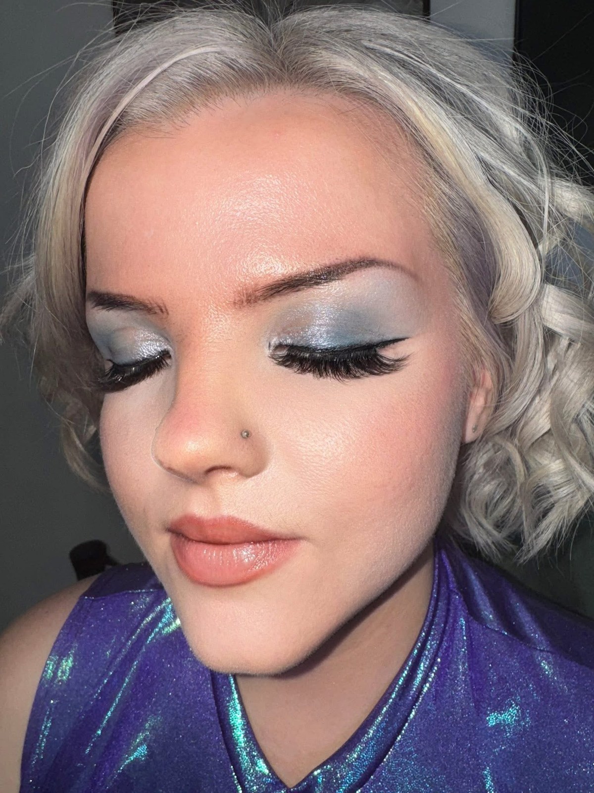 Silver shimmer eye makeup with full lashes
